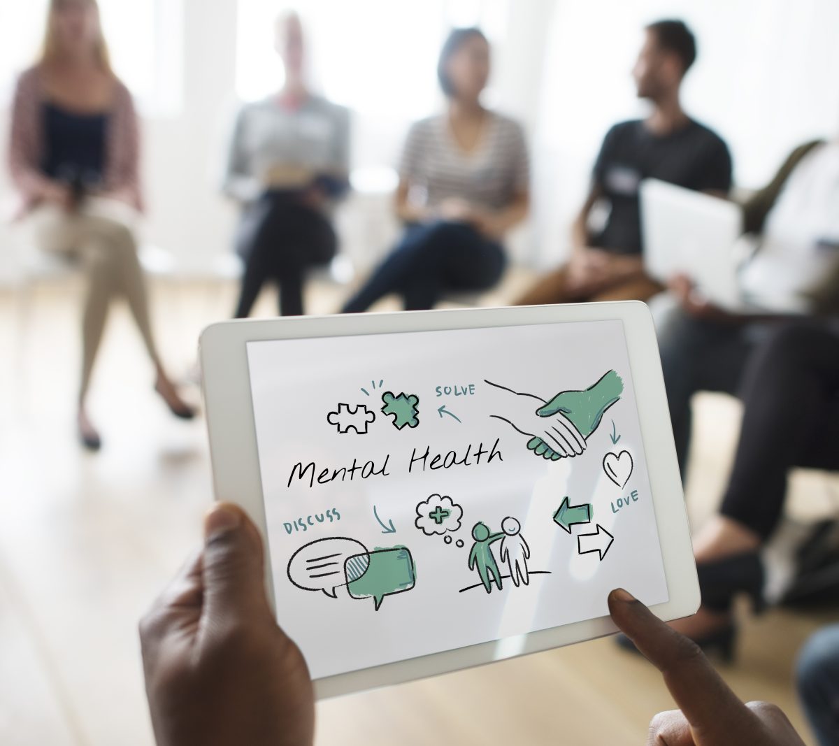 Facilitator presenting a workplace mental health programme to a group session